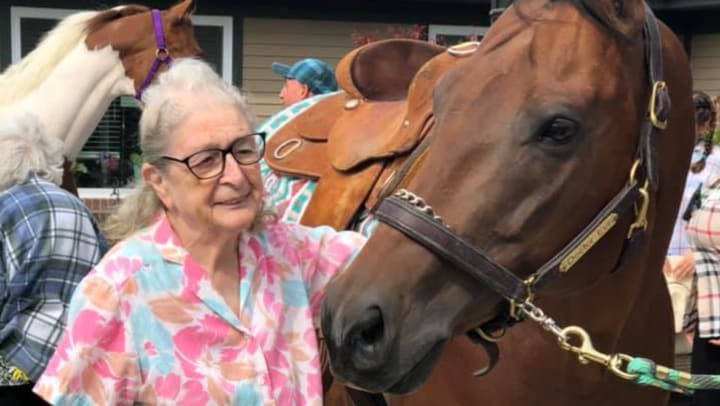 Porter Place resident petting a horse