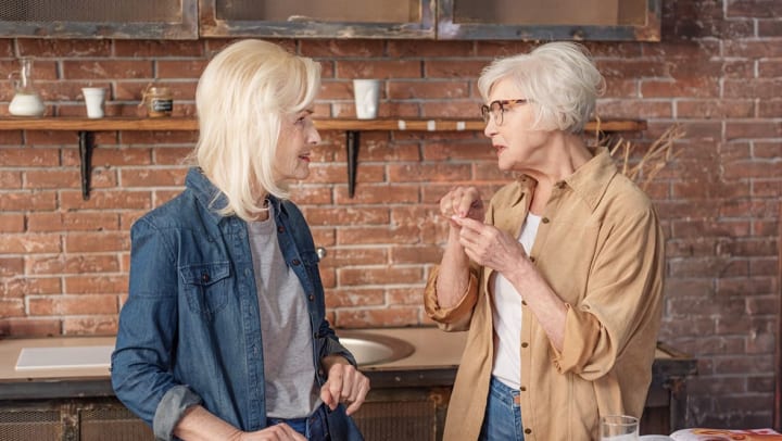 Two women speaking with each other