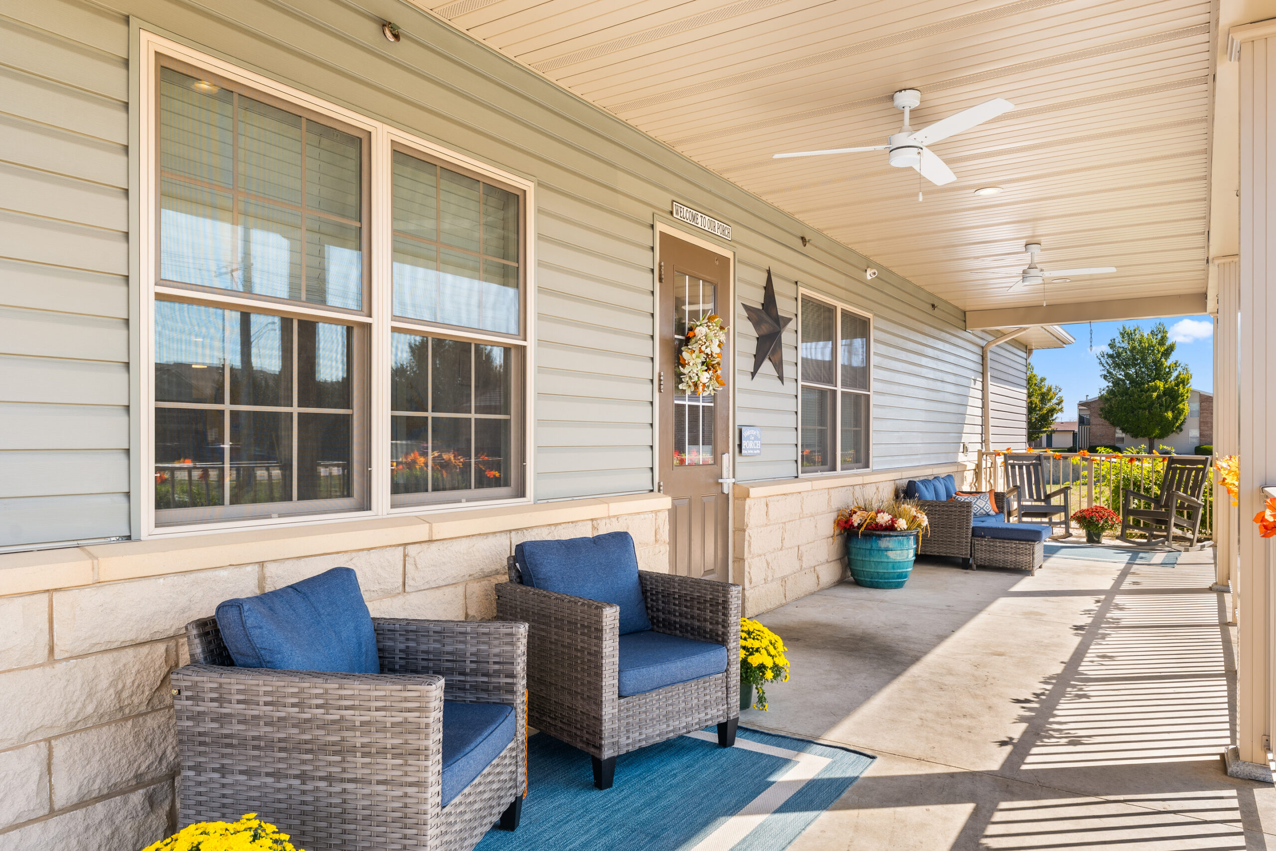 front porch with chairs and flowers