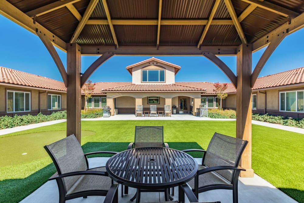 covered outdoor seating with green lawn