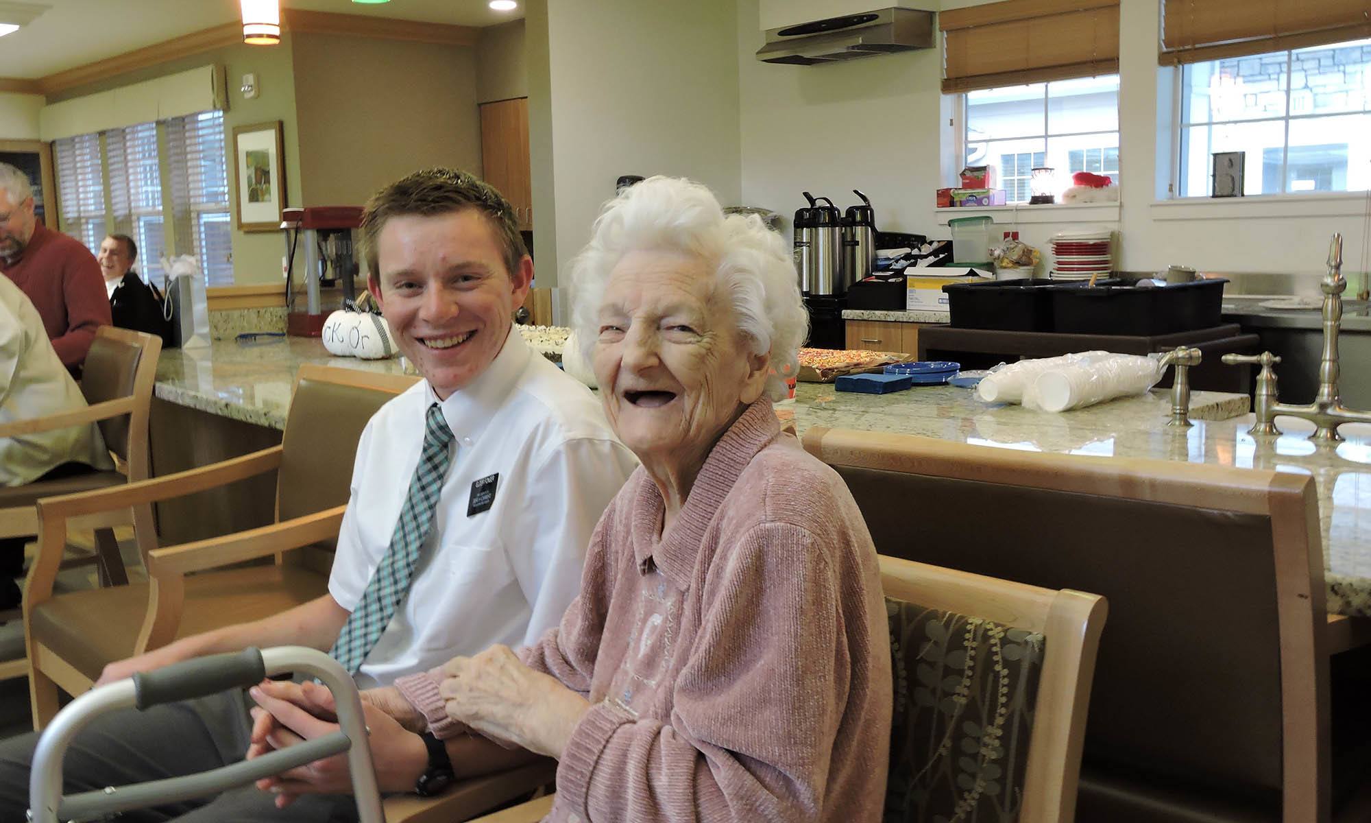 Resident with young man at senior living in Westminster