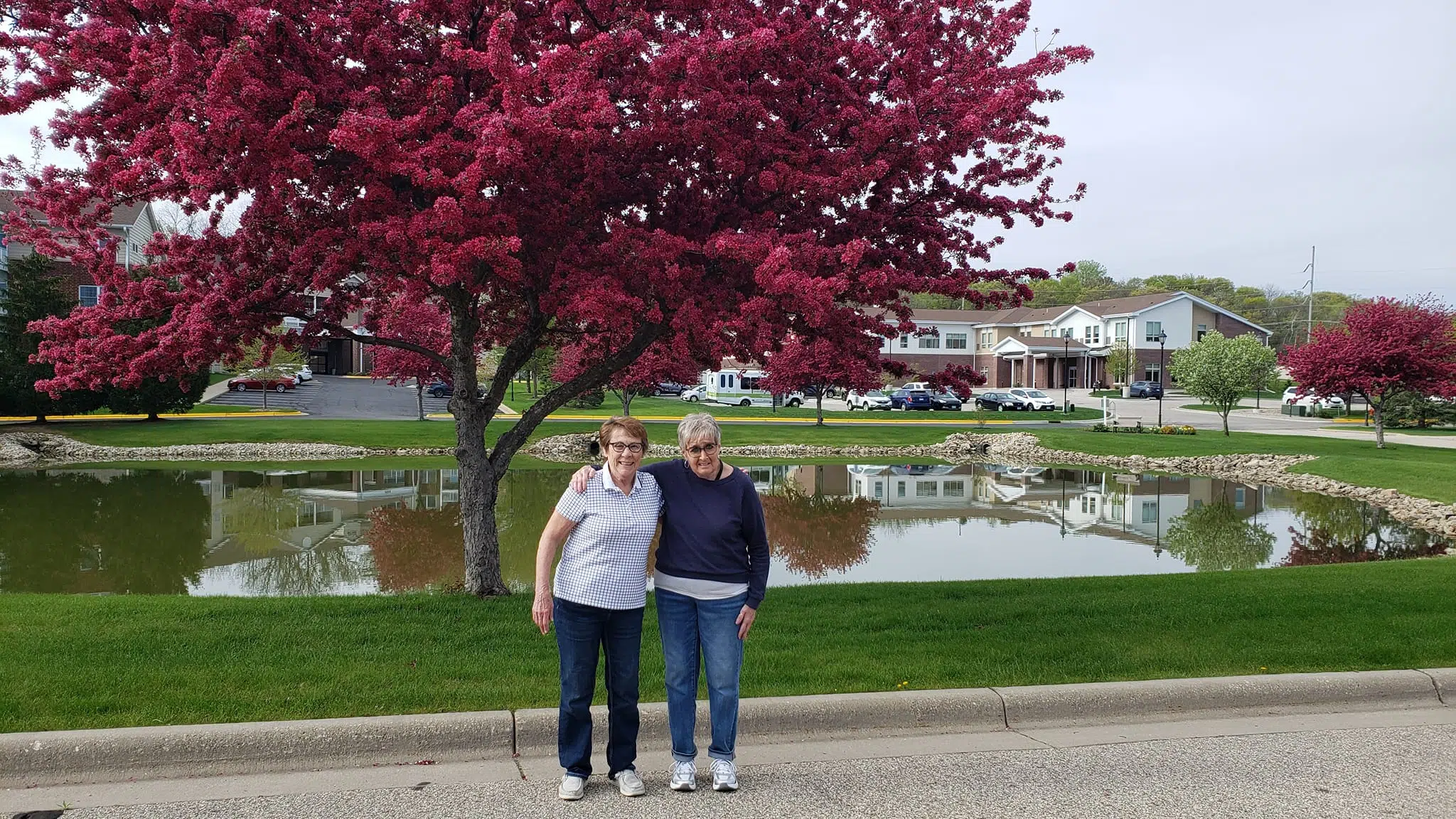 Two Cascade Creek residents standing in front of the community