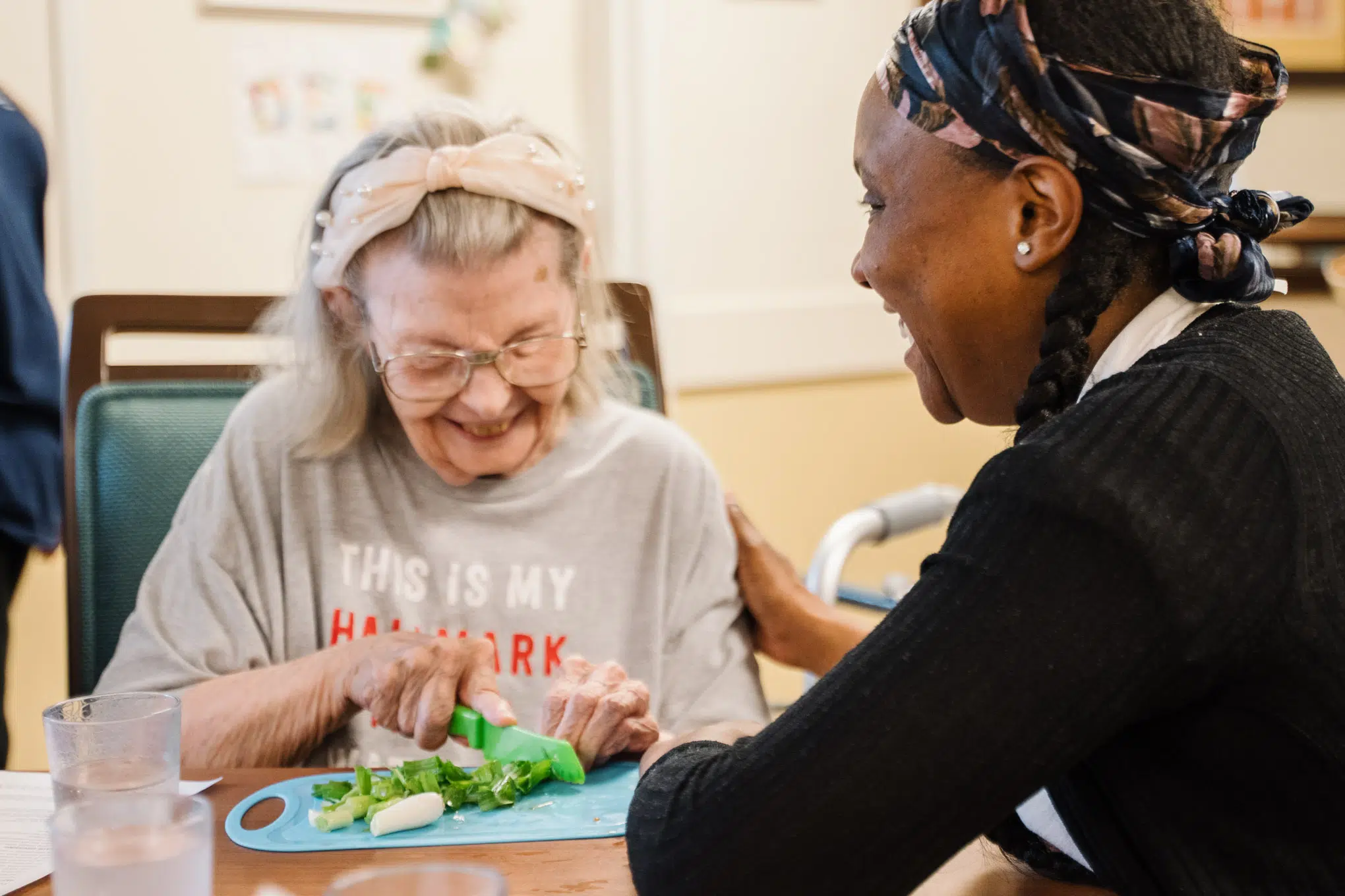Harvester Place resident chopping vegetables
