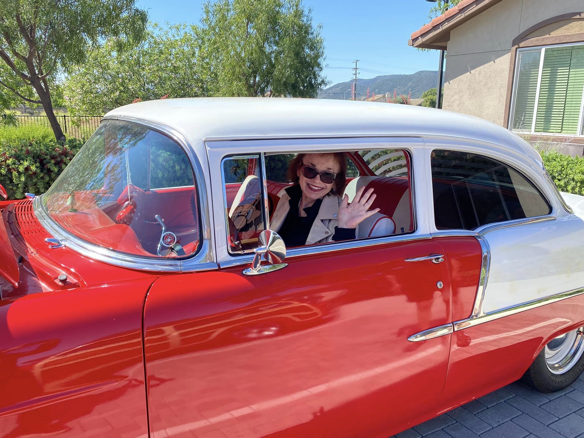 Vineyard Place resident in a red car at the community car show