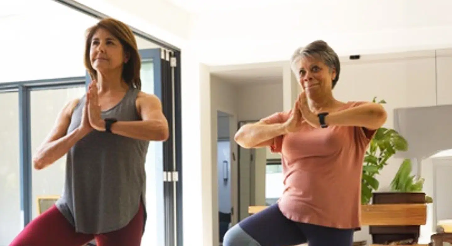 Mother with dementia and daughter engage in yoga together