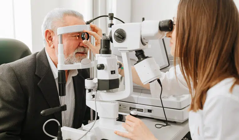 An elderly man with dementia gets a vision exam