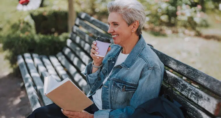 Family caregiver relaxes on park bench