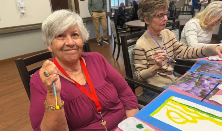 Highline Place Memory Care resident enjoys an art project