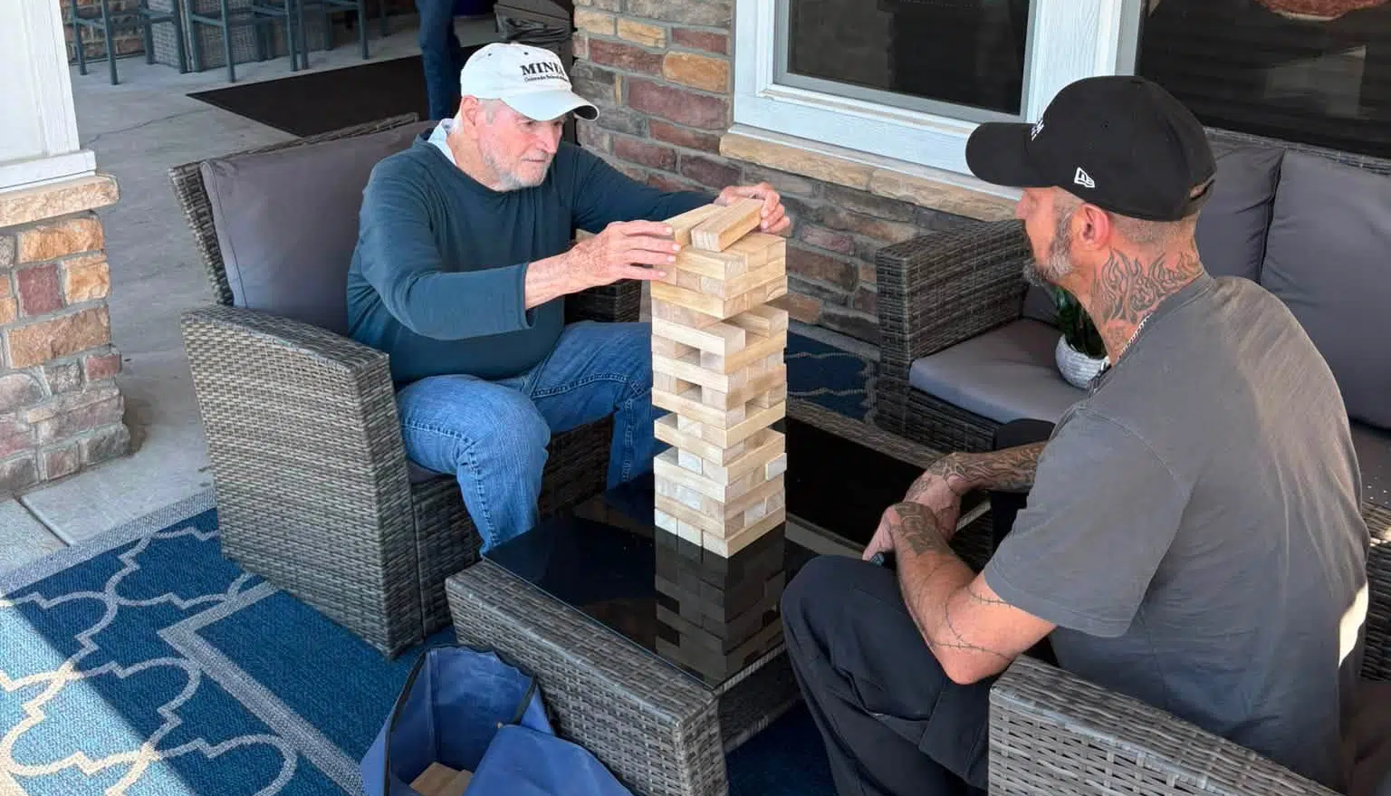 A Highline Place Memory Care resident plays Jenga with the maintenance director